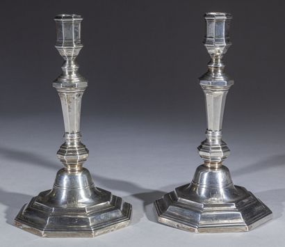 Pair of octagonal silver torches, the base...