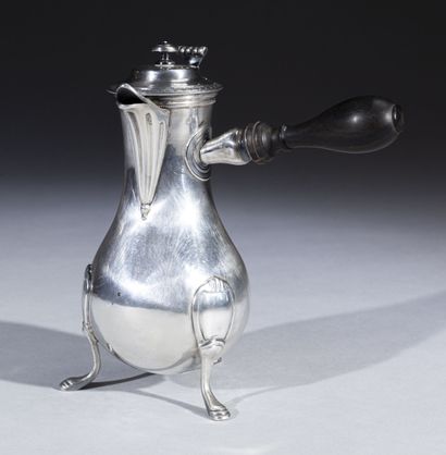 null Baluster coffee pot in plain silver with a straight ebony handle; it rests on...