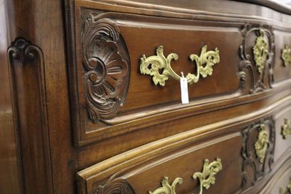 null Walnut chest of drawers with a curved front opening to three drawers carved...