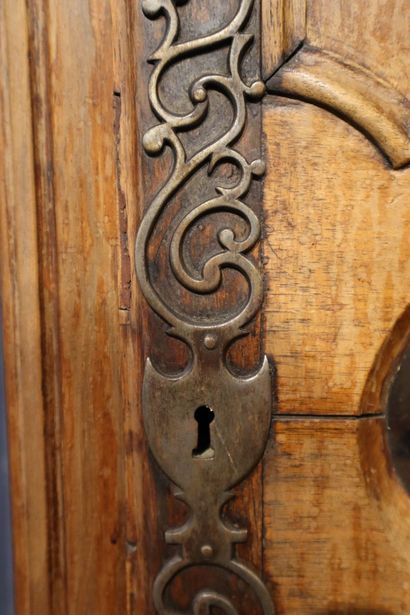 null Straight clock in walnut, opening to a door with carved scrolled panels and...