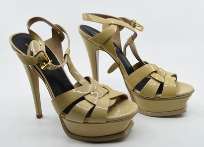 null YVES SAINT LAURENT 
Pair of Tribute pumps in beige patent leather, strap closure...