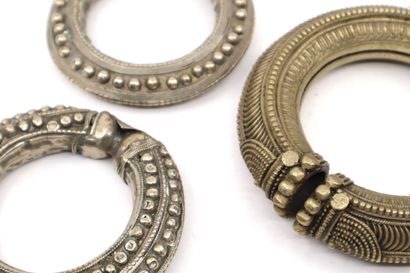 null India, 20th century
Three large hollow bracelets in silver plated metal and...