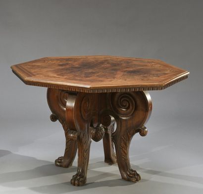 null Une table basse en bois naturel sculpté, plateau octogonal, piètement tripode

Dans...