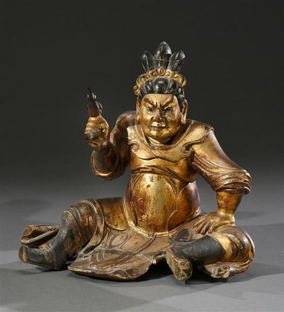 null CHINE - XIXe siècle Statuette en bois laqué d'un gardien assis, l'expression...
