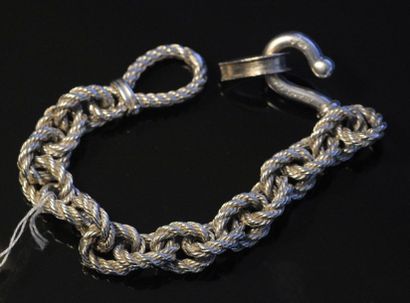 HERMES Bracelet gourmette en argent (800°/°°) à maille forçat tressée
Signé, dans...