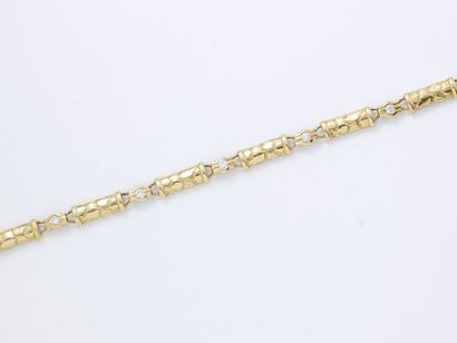 null Bracelet articulé en or 750 millièmes, composé de motifs bâtonnets intercalés...