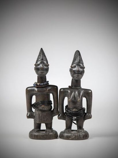 null YORUBA, Nigeria. Pair of male and female Ibedji twins. Arms spread out from...