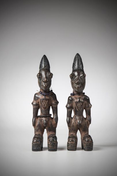 null YORUBA, Nigeria. Male twins with a deep red ochre patina based on camwood and...