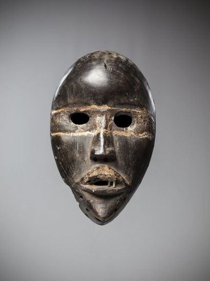 null DAN, Ivory Coast. Racing mask with round eyes surrounded by a resin band that...