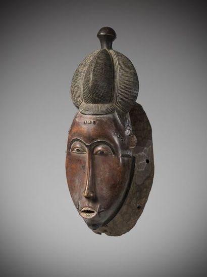 null BAOULE, Ivory Coast. Feminine "Kpan" mask with a beautiful elongated face coated...