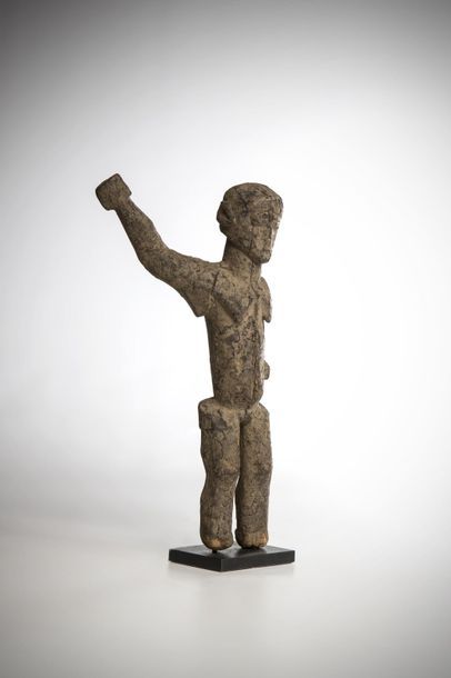 null LOBI, Burkina Faso. Female statue with her right arm raised. Face with geometric...