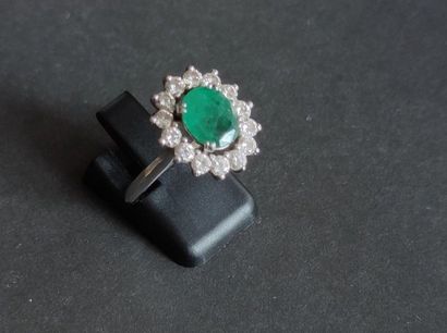 null RING "Flower" in white gold 750°/°°° set with a central cut emerald (about 1...