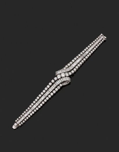 null Flexible platinum bracelet, forming a line of round brilliant cut diamonds falling...