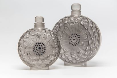 null "Dahlia" - (1930s)

Two moulded colourless pressed glass flasks of rectangular...