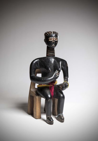 null KOULANGO (Ivory Coast)

Female figure in sitting position, arms folded up suggesting...