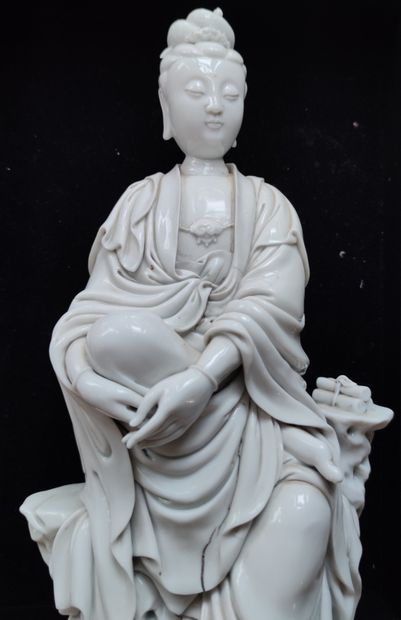 null 
STATUETTE en porcelaine blanche représentant Kwan-In assise sur un rocher,...