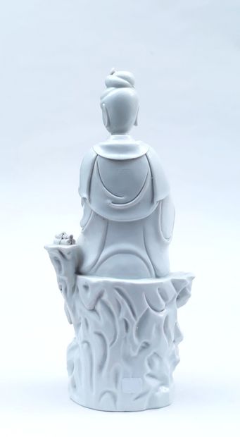 null 
STATUTE in white porcelain representing Kwan-In sitting on a rock, stamp on...