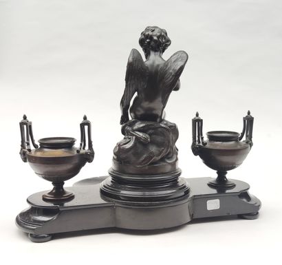 null 
INK in black marble and bronze with a motif of a cherub sitting on a rock surrounded...