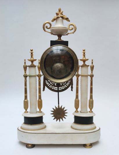 null 
Portico-shaped white marble CLOCK with chased and gilded bronze ornamentation...