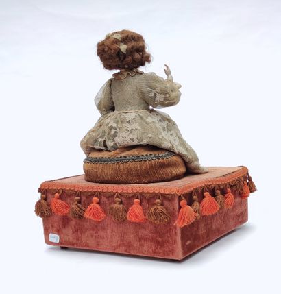 null AUTOMAT representing a young woman sitting on a sofa in a lace dress, head,...