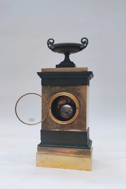 null A dark green patinated and gilt bronze clock with an antique basin decoration,...