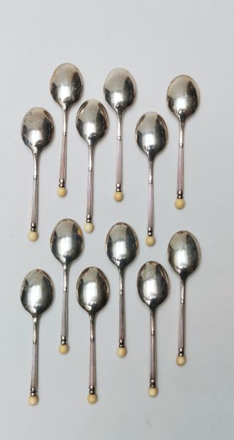 null 
12 Silver mocha spoons with ivory ball design, 20th century 




Gross weight...