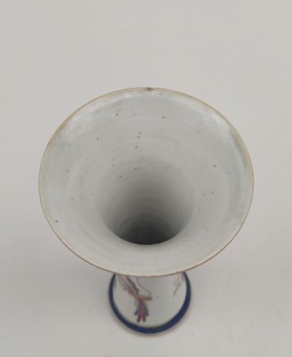 null A small porcelain VASE of tubular form with a horn-shaped neck, decorated with...