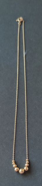 null LOT of three yellow gold necklaces with horseshoe, line of declining balls,...