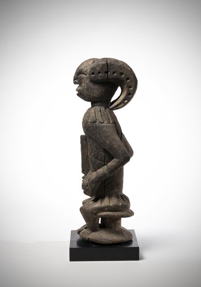 null Ibo (Nigeria) Statue of cult "Ikenga" representing a warrior holding his cuff...