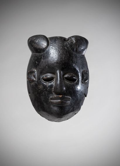 null Ibibio (Nigeria) Facial mask with a deep black lacquered patina and a hairstyle...