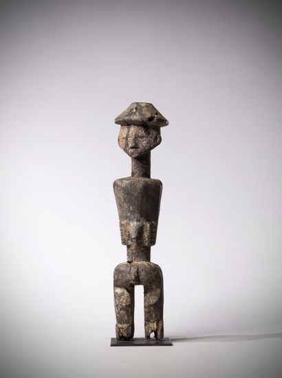 null Ijo (Nigeria) Male statue wearing a truncated conical headdress. The arms stuck...