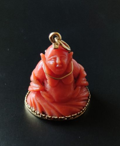 null PENDANT, the setting in yellow gold 750°/°° supporting a seated Buddha in red...