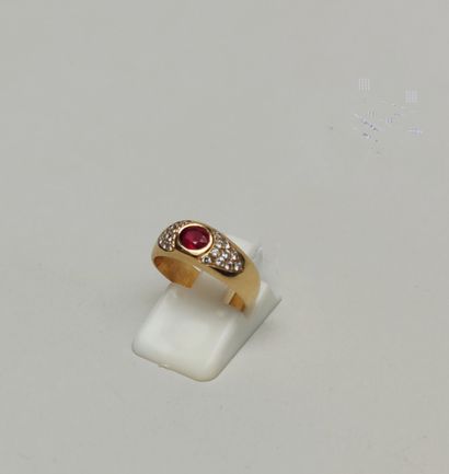 null 
Yellow gold ring 750°/°° set with a small cut ruby on a pavement of small cut...