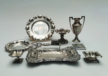 null 
A silver set including three saltcellars, a mouchette with its tray on ball...