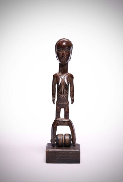 null Ivory Coast
Loom pulley support representing a female figure standing on the...