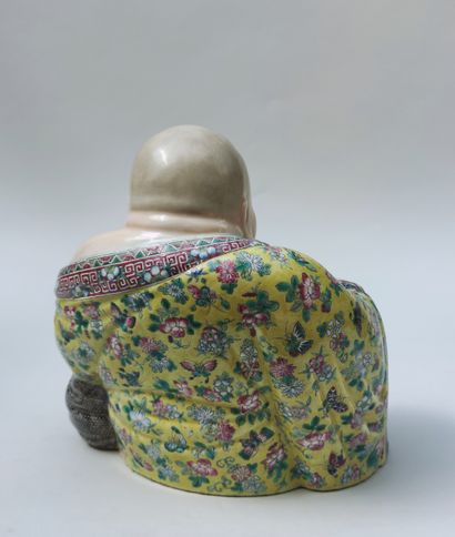 null Seated smiling BUDDHA holding a rosary in polychrome enameled porcelain, China....