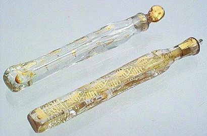 null Deux flacons longilignes en cristal avec décor peint en or, bouchons en cristla....