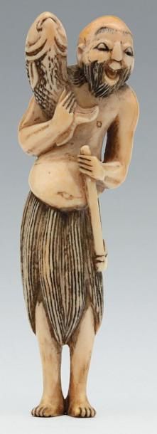 null NETSUKE en ivoire représentant un pêcheur vêtu d'un pagne tenant une carpe et...