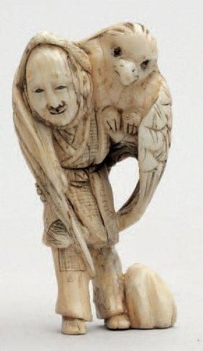 null NETSUKE en ivoire représentant un fauconnier portant un rapace enveloppant ses...