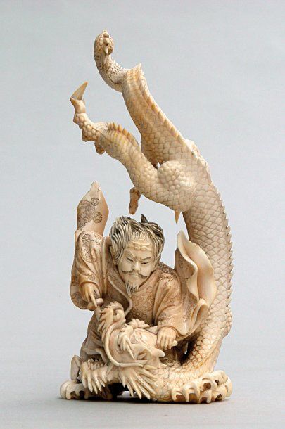null OKIMONO en ivoire représentant un guerrier combattant un dragon. Signé Yoshitoshi....