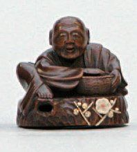 null NETSUKE en bois représentant le célèbre jardinier Hanasakajiji assis sur une...