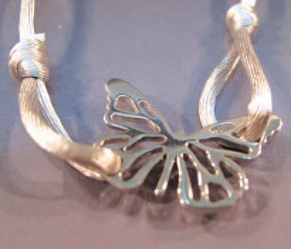 FLORENCE LAROCHAS bracelet orné d'un papillon repercé en argent sur cordon de soie...