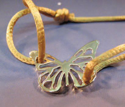 FLORENCE LAROCHAS bracelet orné d'un papillon repercé en or jaune sur cordon de soie...