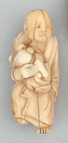 null CHARMANT NETSUKE représentant un arraht (disciple de bouddha) portant un chien....