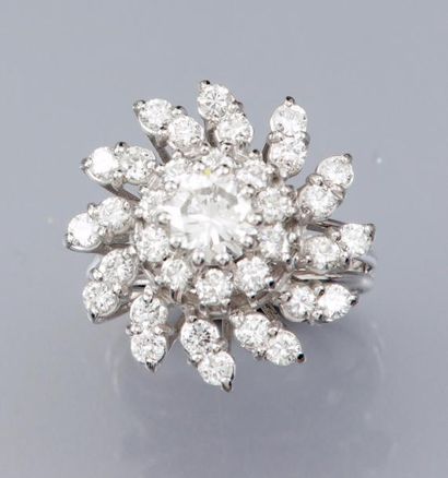 null Bague fleur 750°/00 fileté, sertie d 'un diamant taille brillant de 0.80 ct...