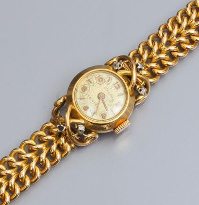  Montre bracelet de dame en or jaune 750°/00, à boitier rond à attaches filetées...