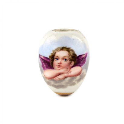  A porcelain Easter egg with a painted Raphael angel, golden vignette and decorative... Gazette Drouot