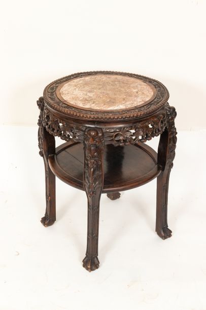  China, circa 1900 Round quadripod pedestal table in exotic wood, carved and openwork,...