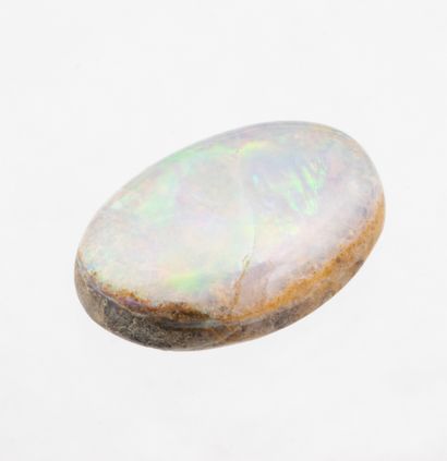  2.5 ct. white boulder opal with red, green and blue flashes. A crack runs through...