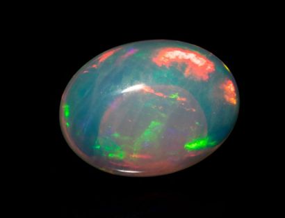  2.96 ct. oval transparent white opal with beautiful rolling flashes of bluish green,...